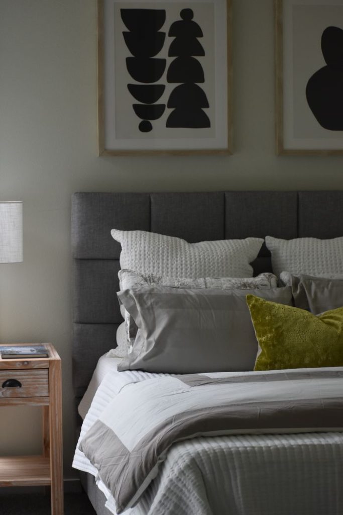 Cozy and inviting modern bedroom featuring elegant decor and abstract art.